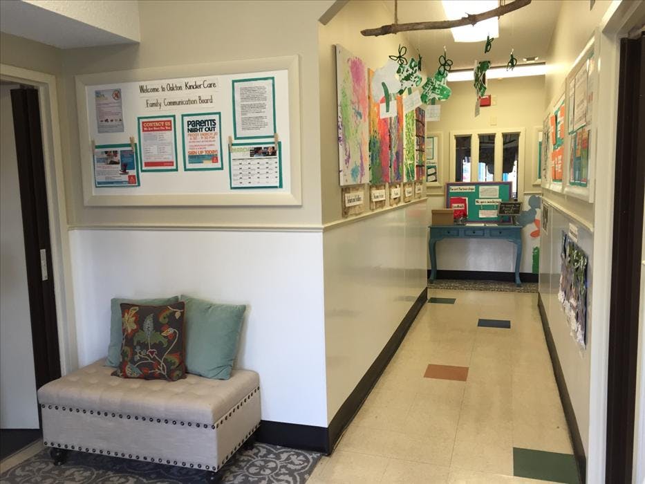 Hallway in a childcare center with a communication board and children's artwork