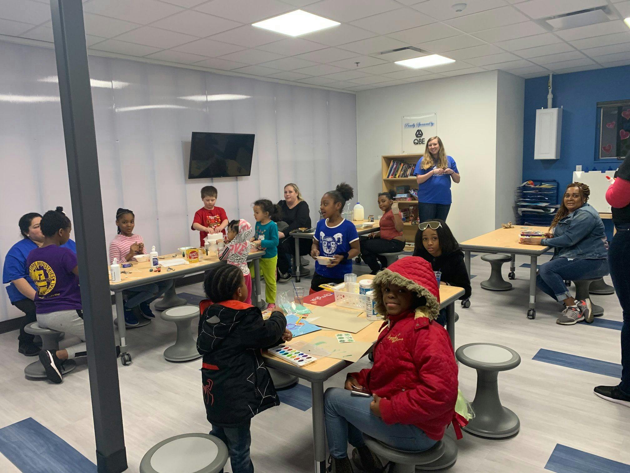 People and children in a classroom setting