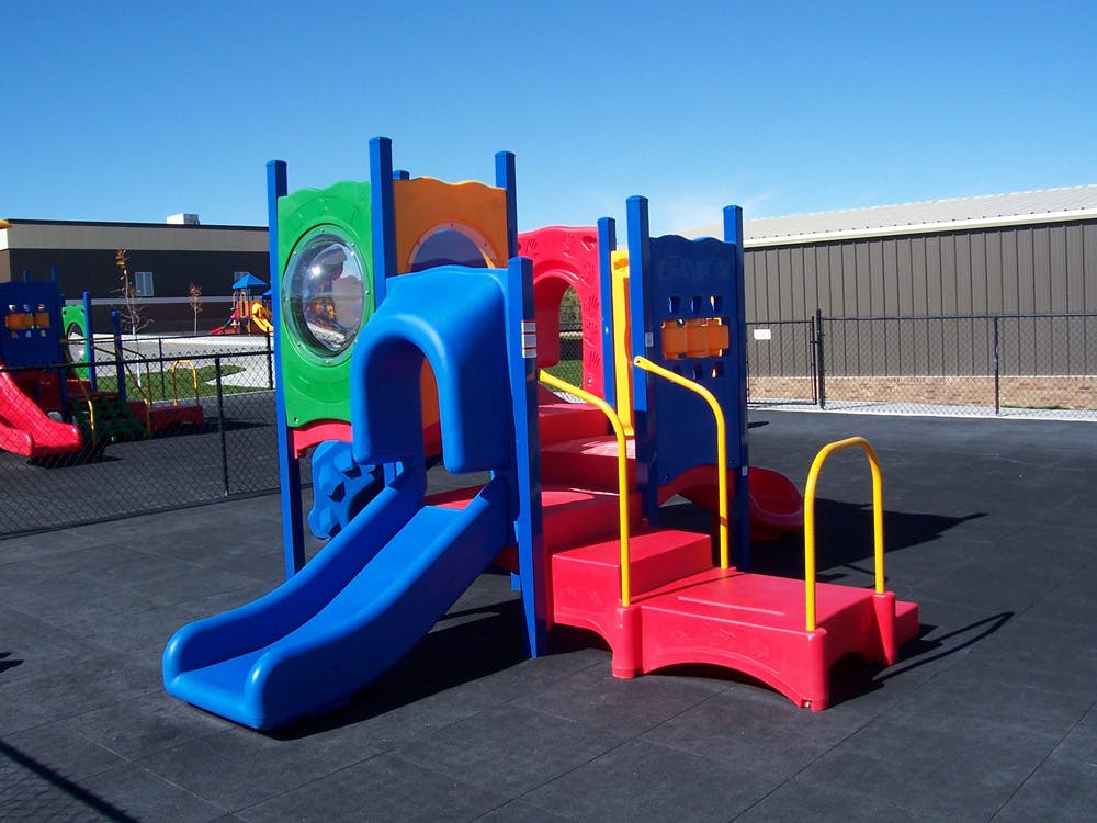 Colorful playground structure with slides and stairs