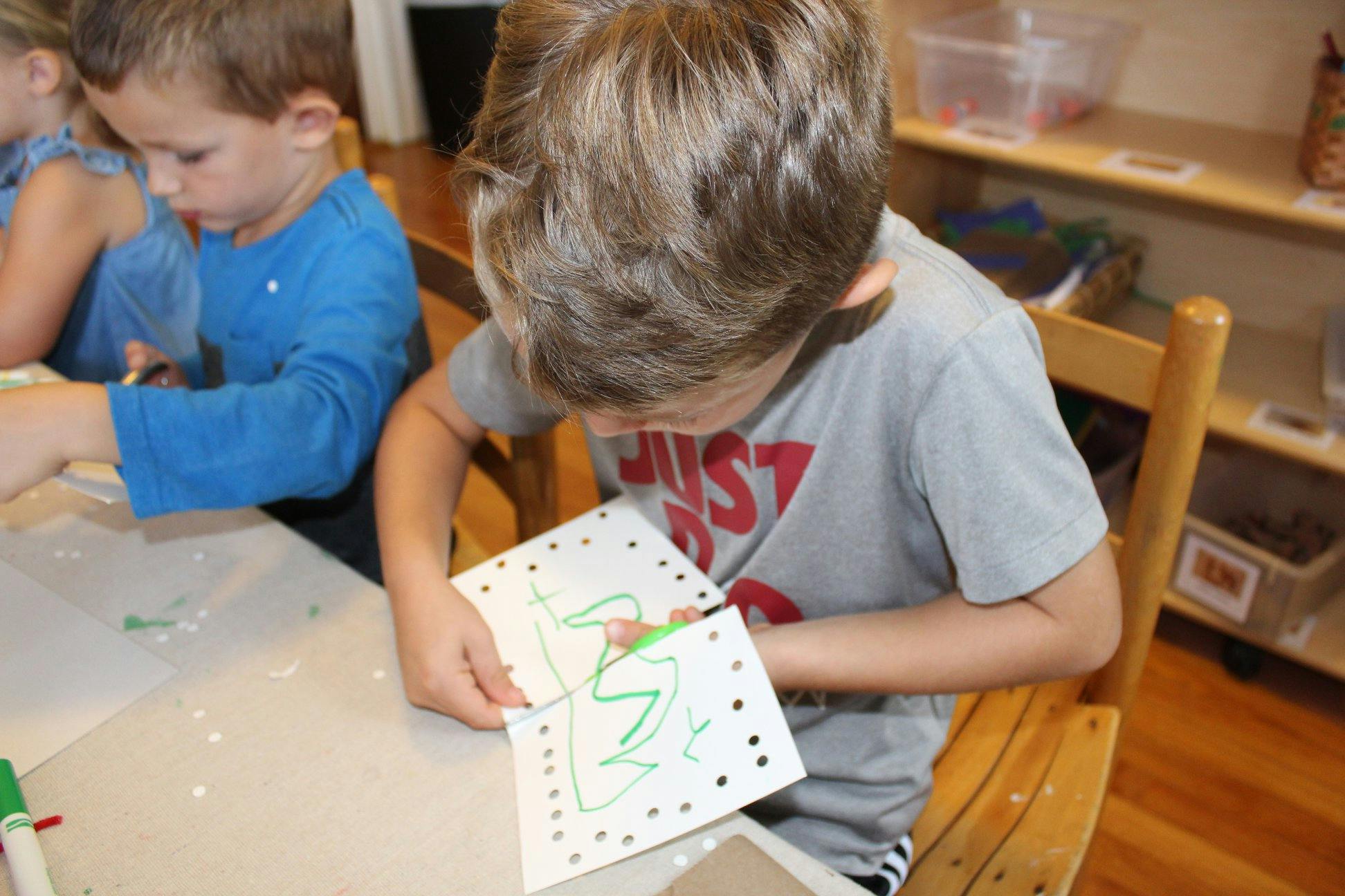 Child cutting paper with scissors