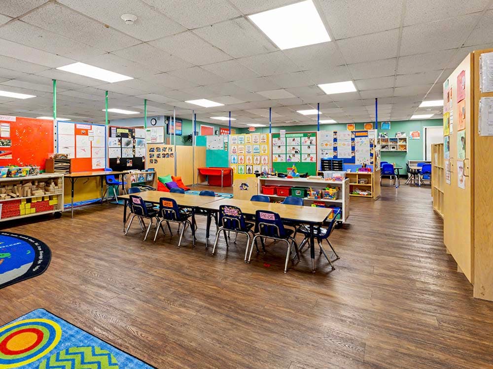Classroom with tables, chairs, and colorful wall displays