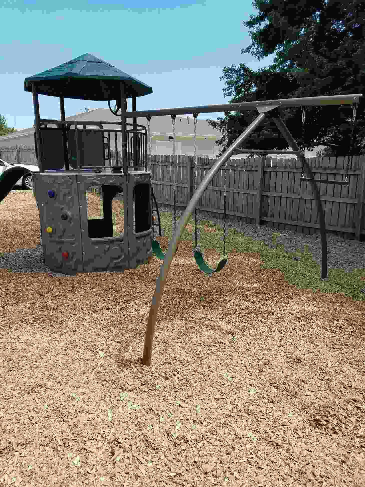 Playground with a play structure and swing set