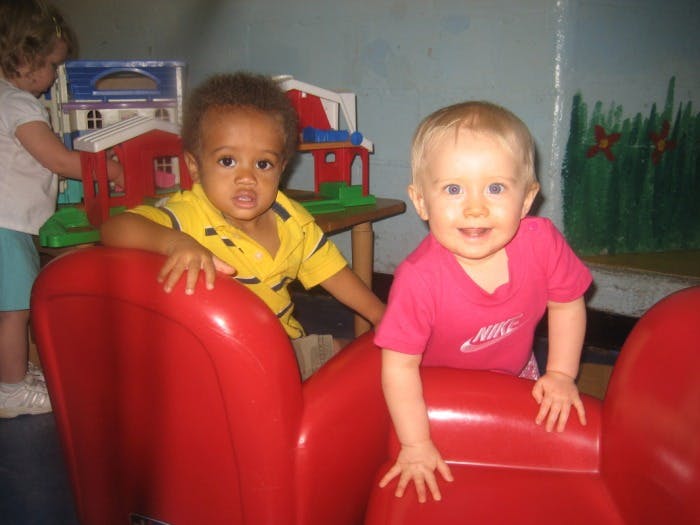 Two children in red chairs