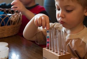 Child playing with a colorful counting toy