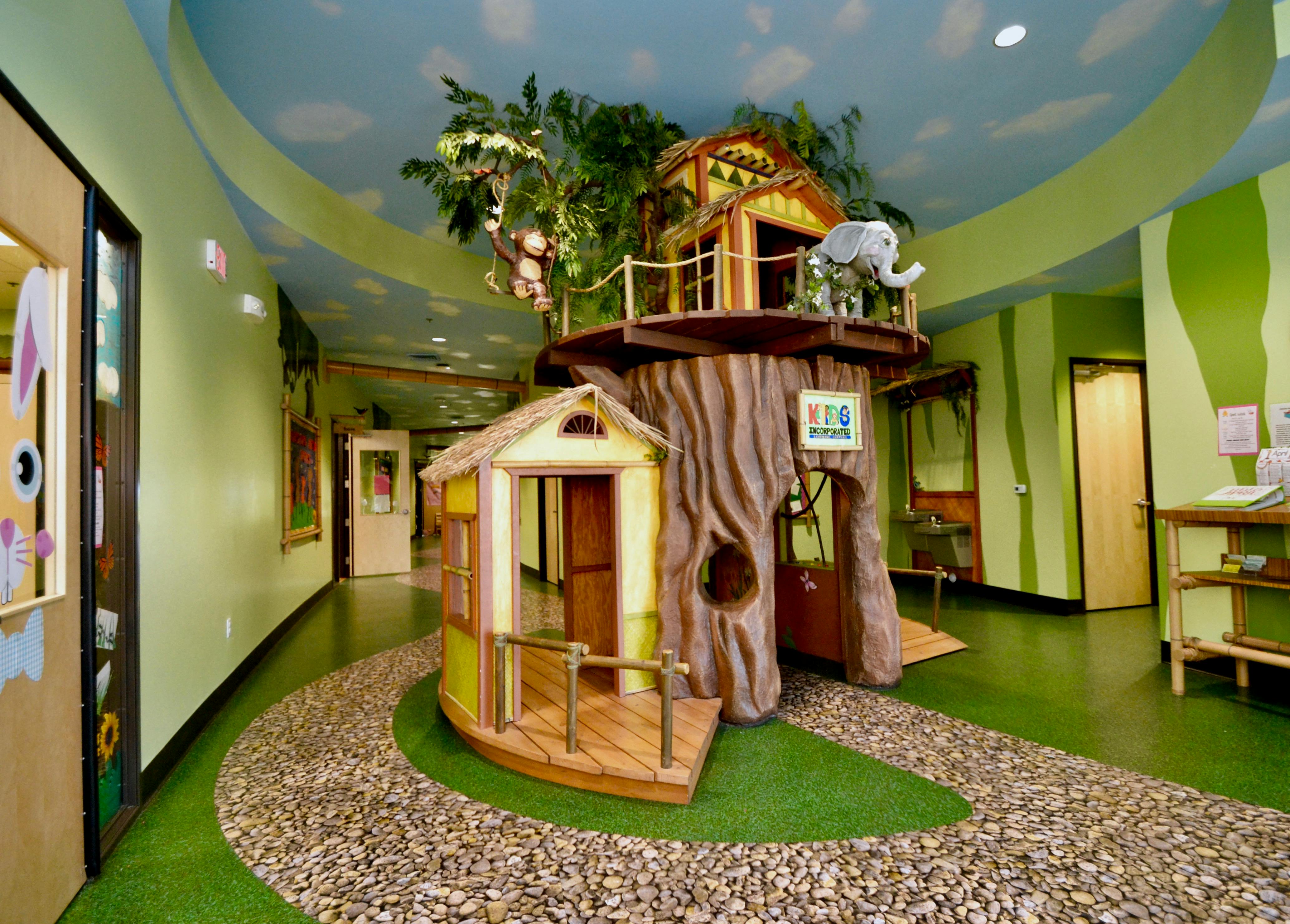 Indoor play area with treehouse and small play hut