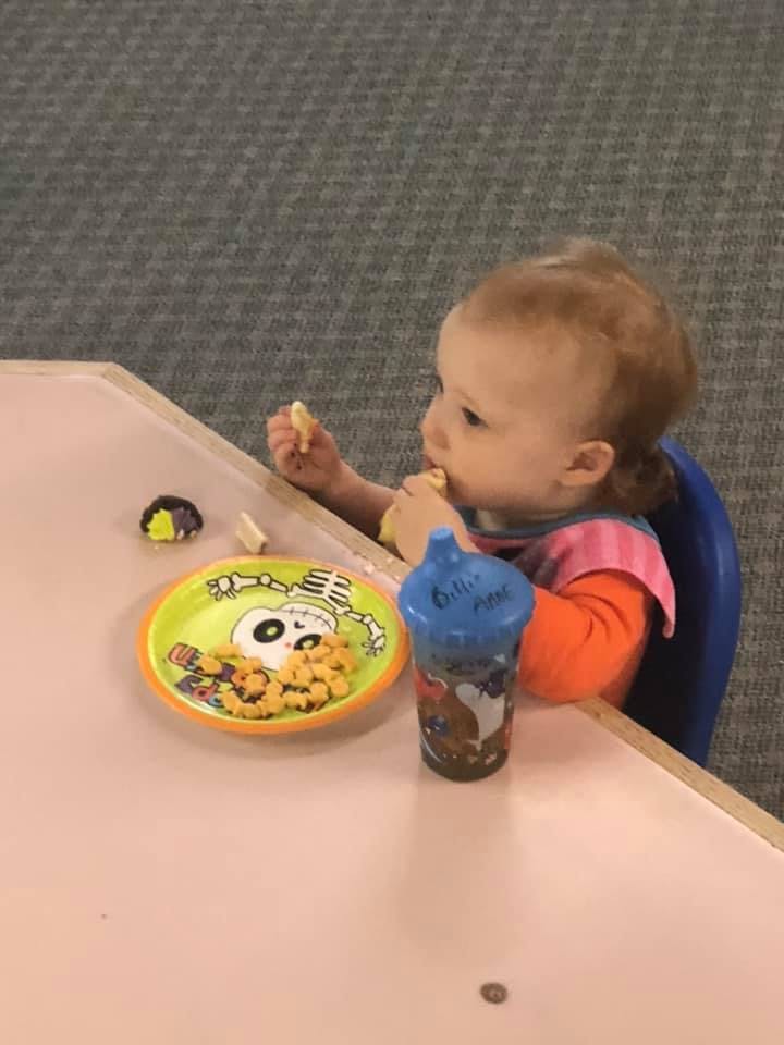Child eating snacks at a table