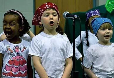 Children singing into a microphone