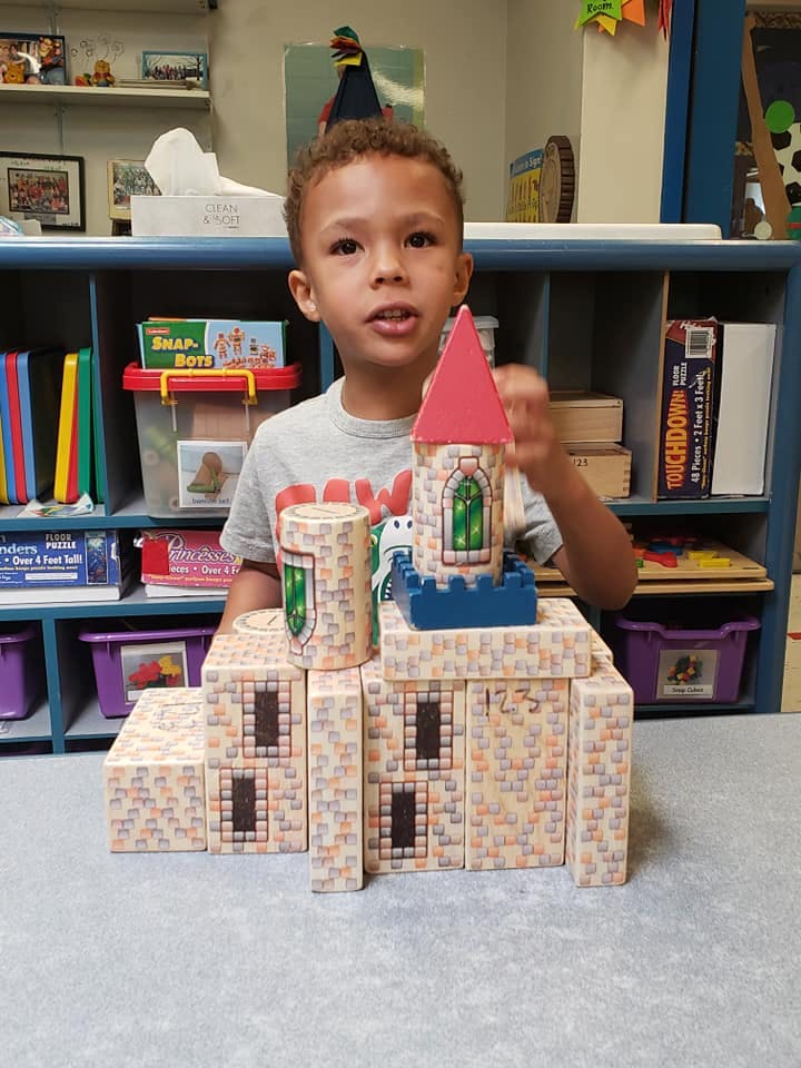 Child playing with a toy castle