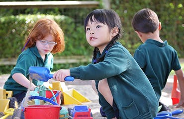 Child playing with sand toys outdoors