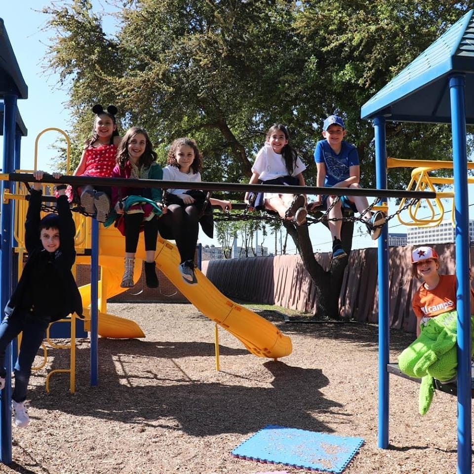 Children playing on a playground structure