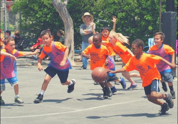 Children playing basketball outdoors