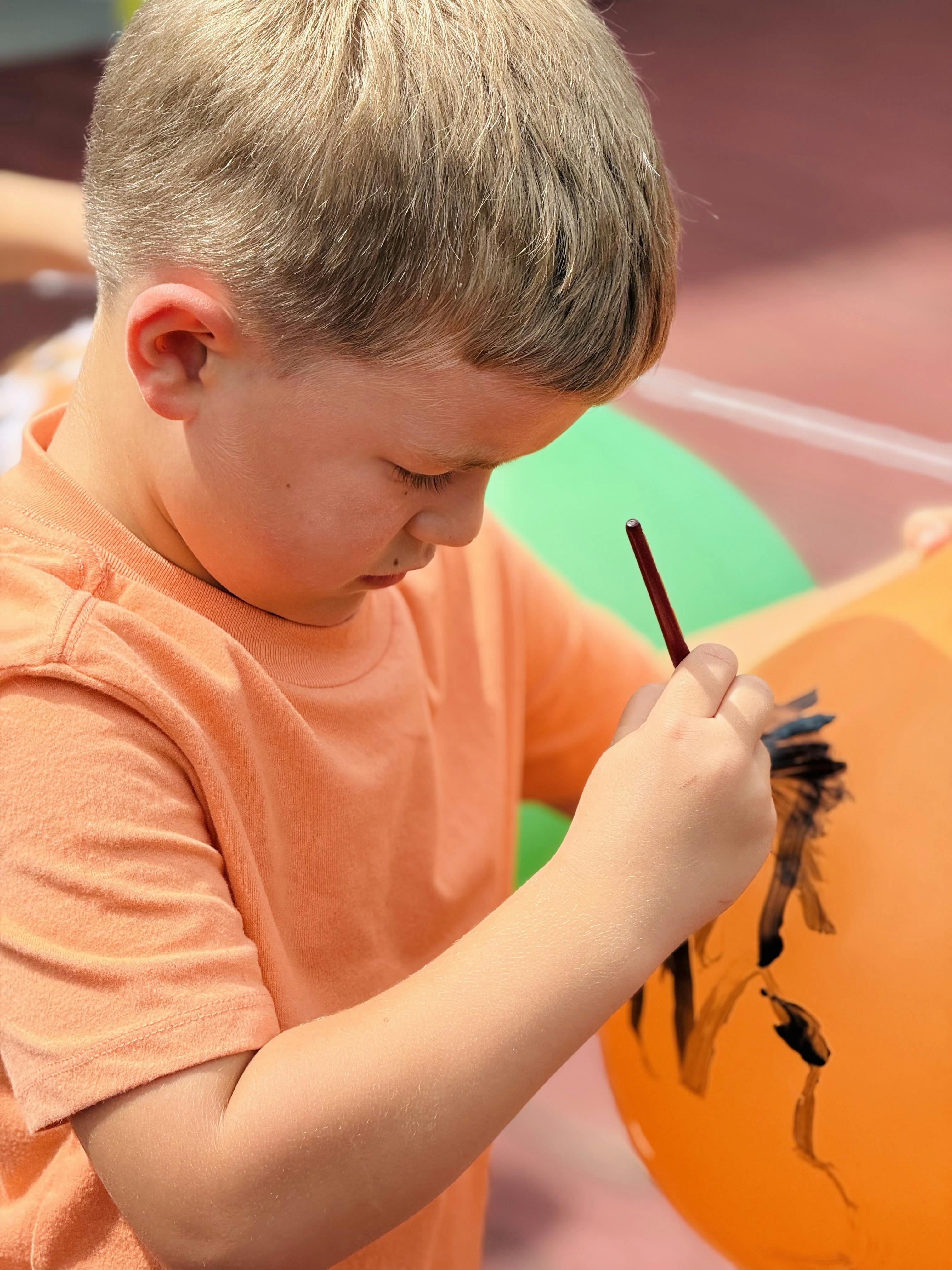 Child painting on a balloon