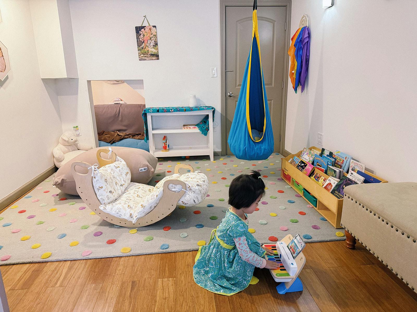 Child playing with a toy piano in a playroom