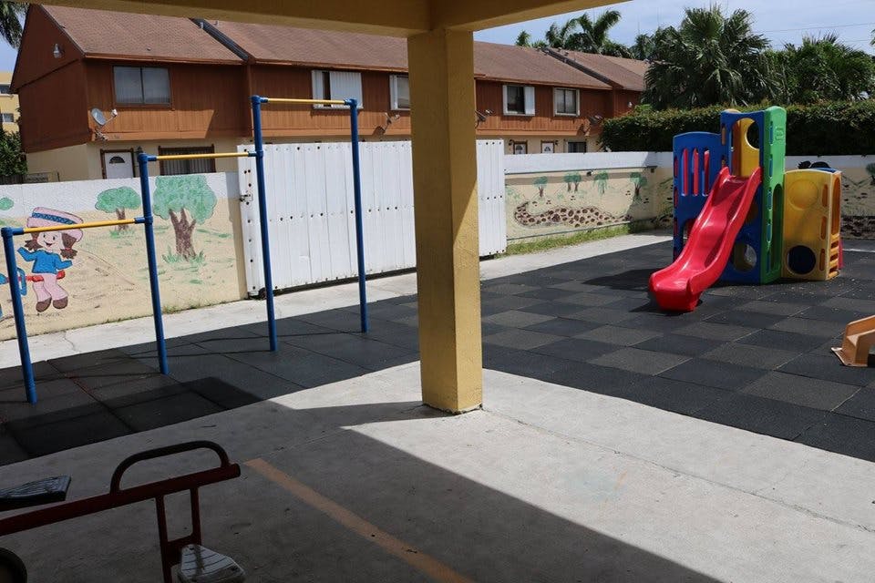 Playground with a red slide and monkey bars