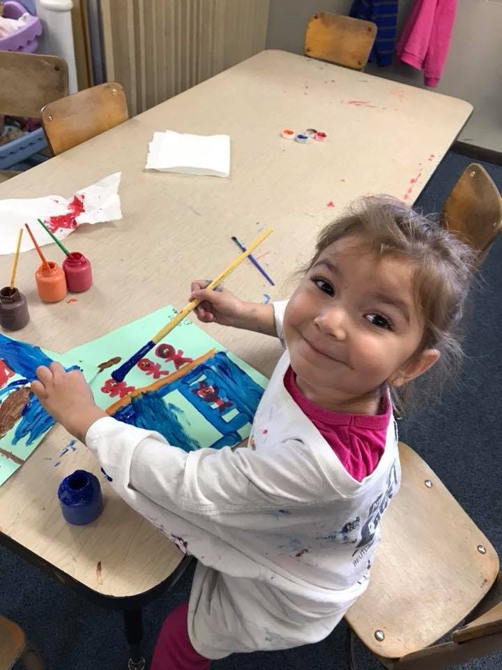 Child painting at a table