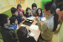 Adult and children gathered around a table