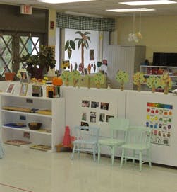 Empty classroom with small chairs and shelves