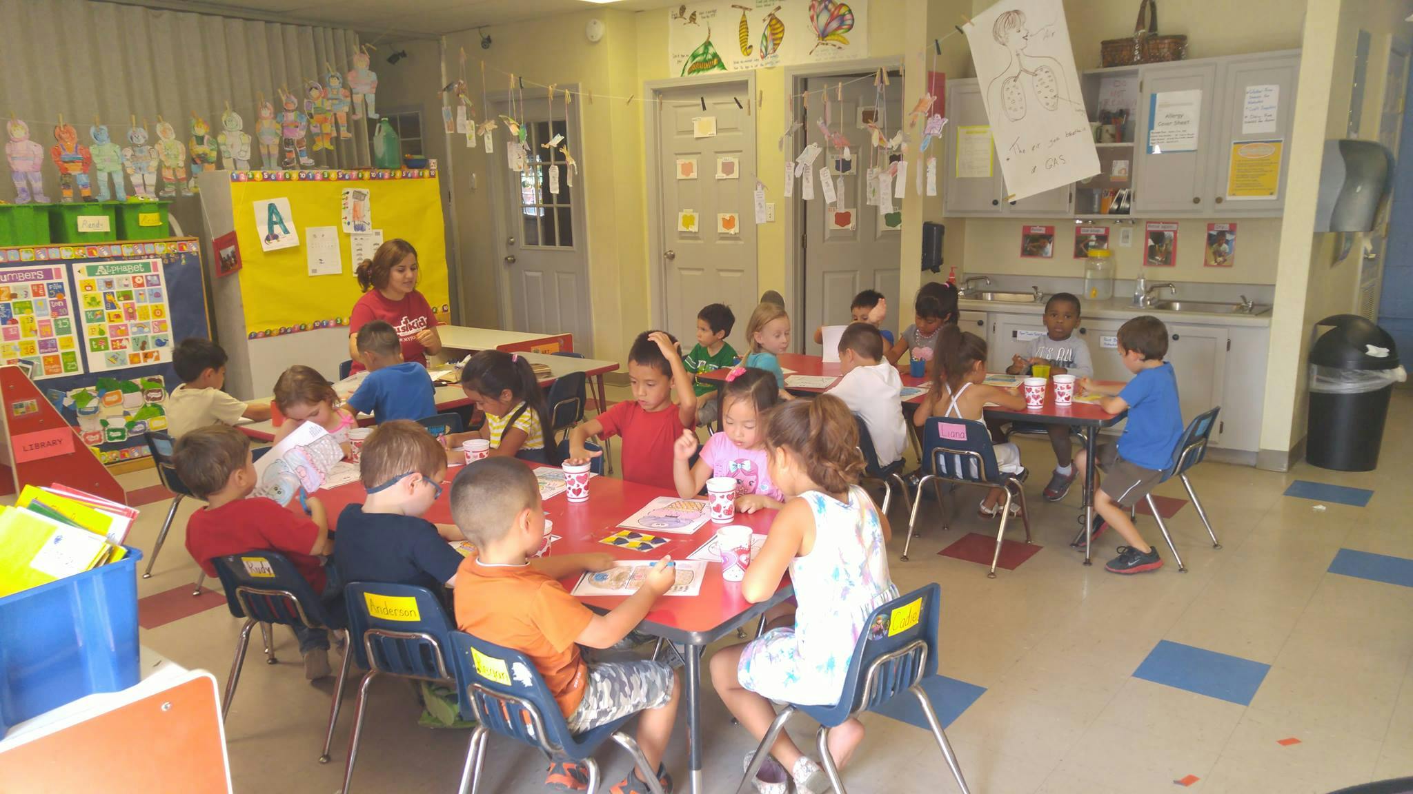 Children sitting at tables in a classroom