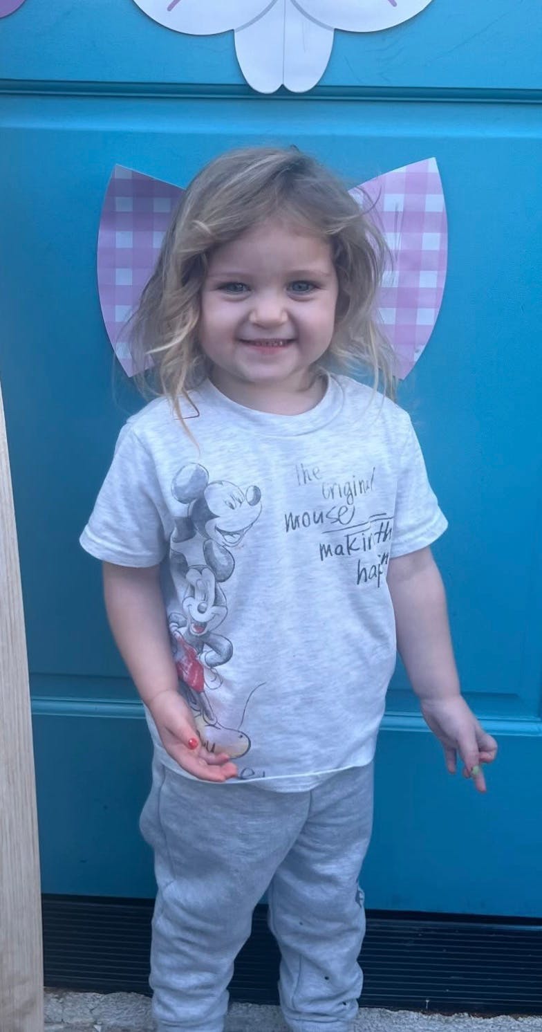 Child standing and smiling
