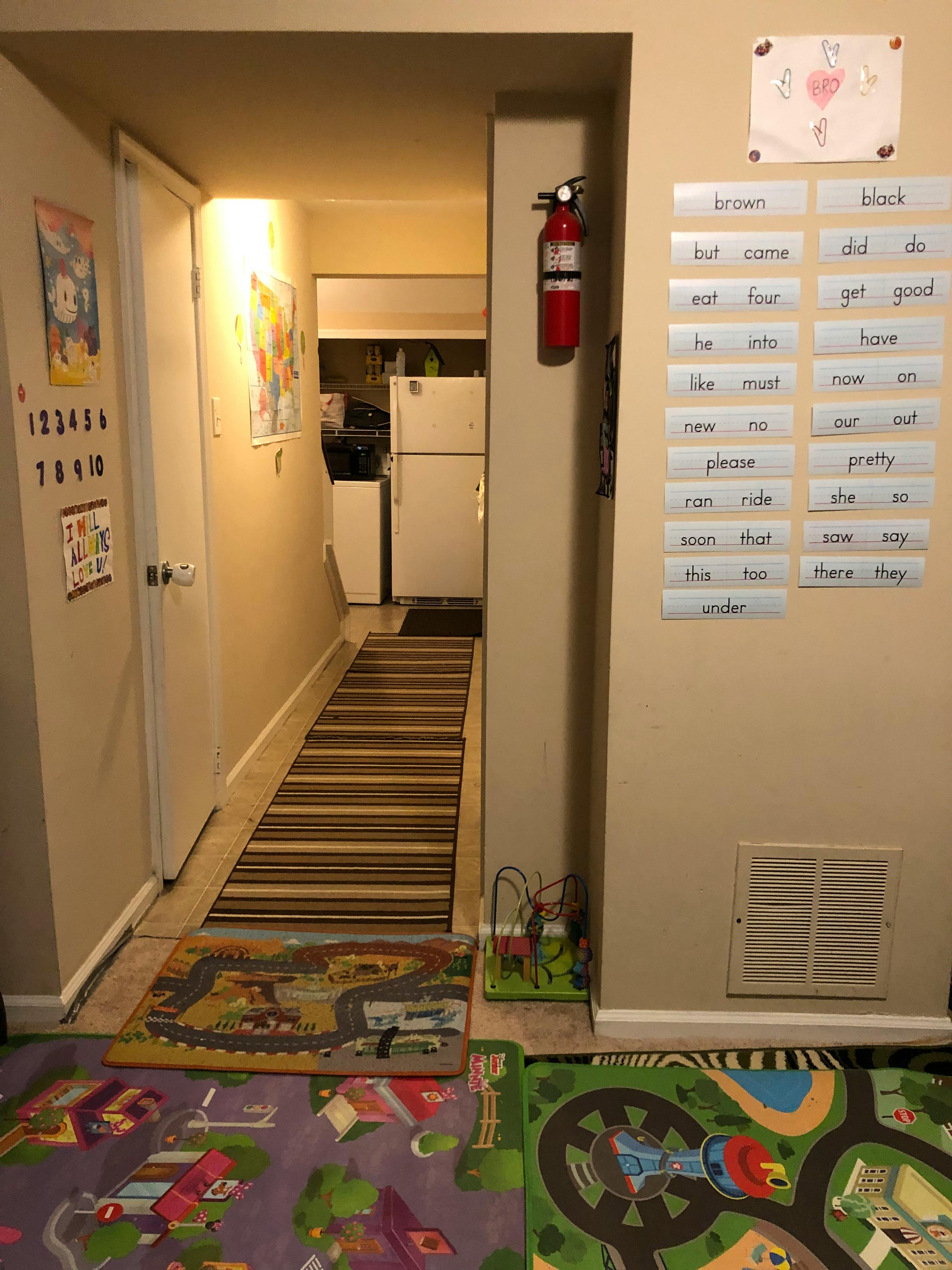 Hallway with a fire extinguisher and word cards on the wall