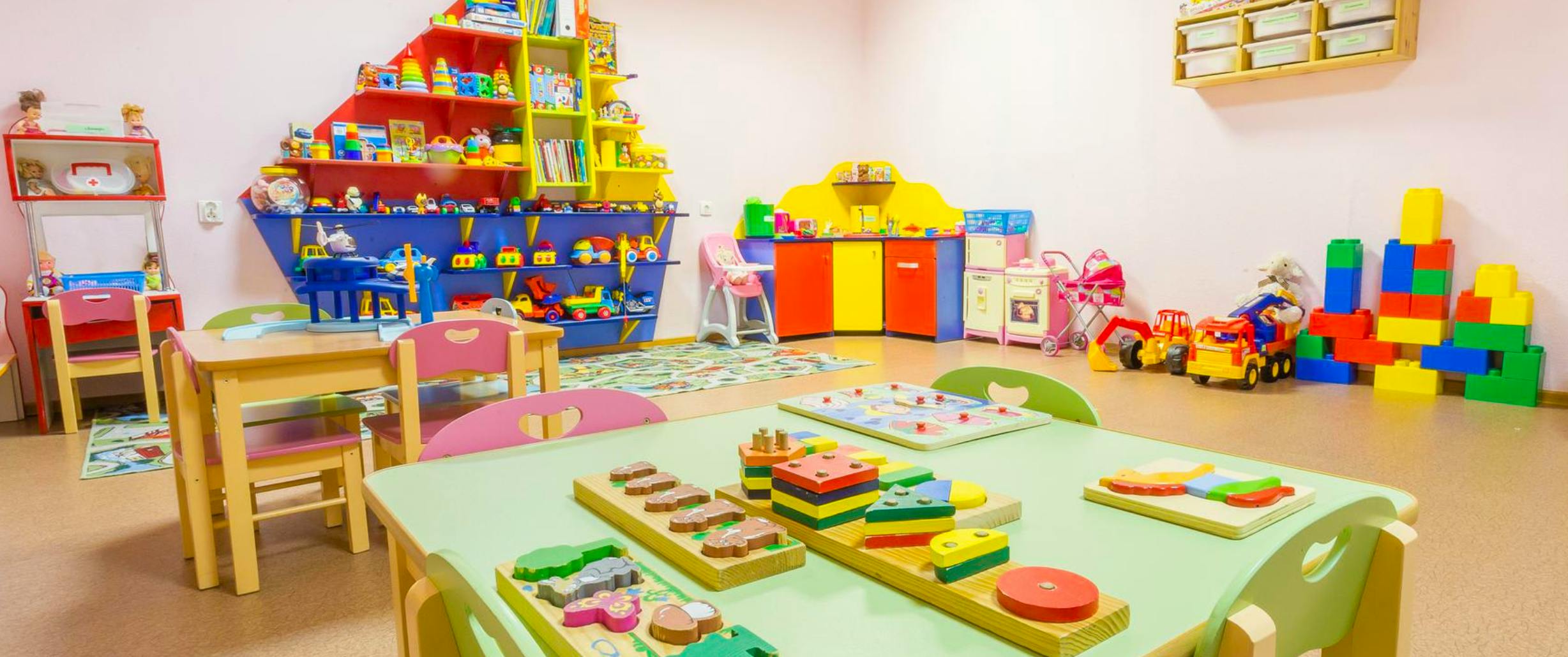Playroom with colorful toys, tables, and chairs