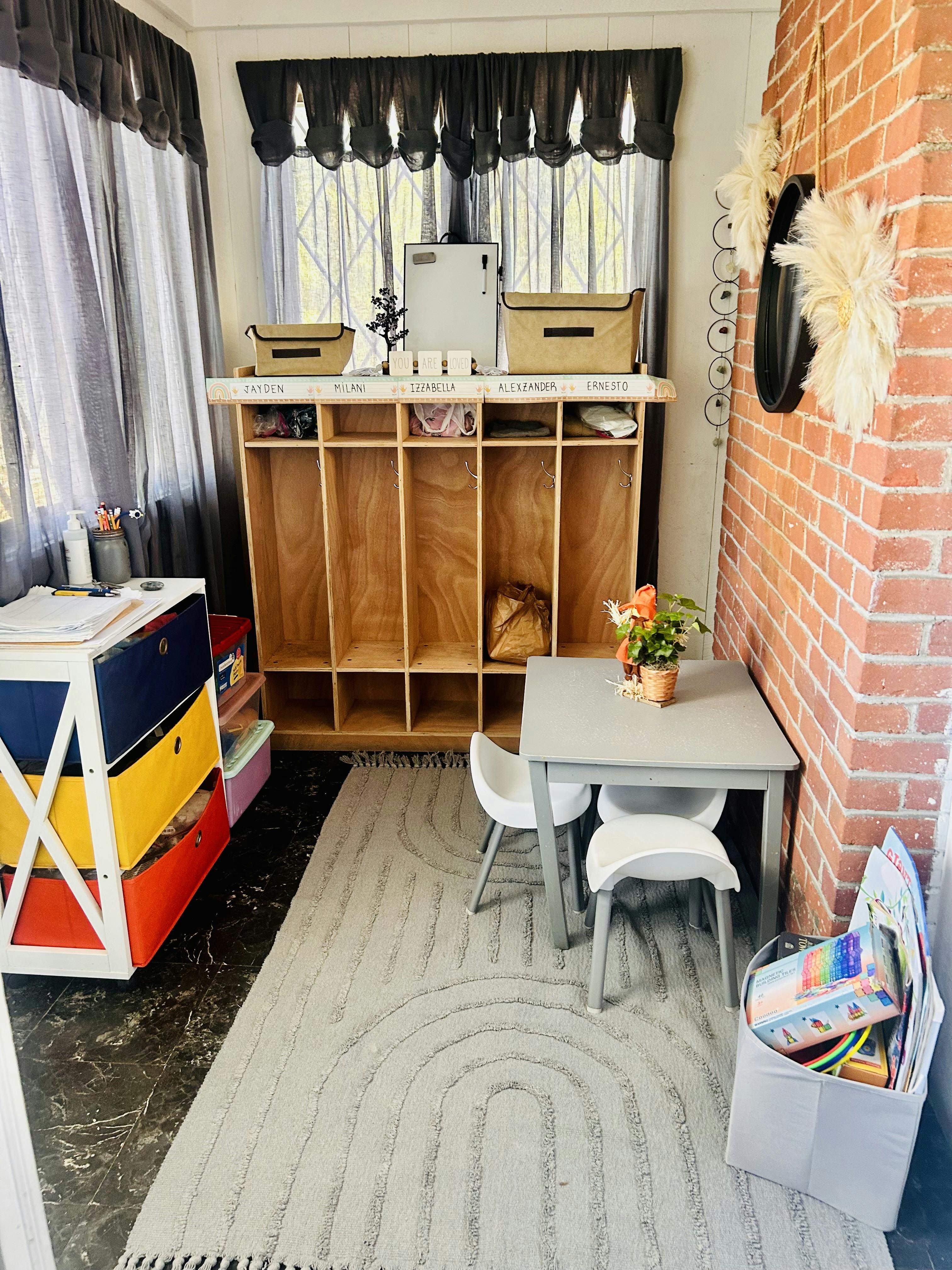 Children's play area with cubbies, small table and chairs, and toy storage