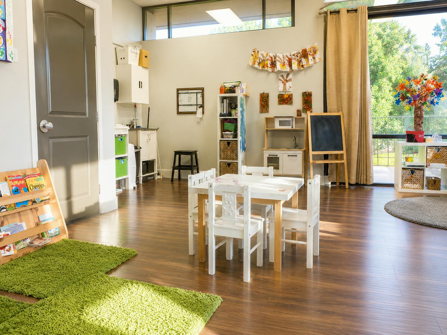 Classroom interior with a small table and chairs and child-sized play furniture