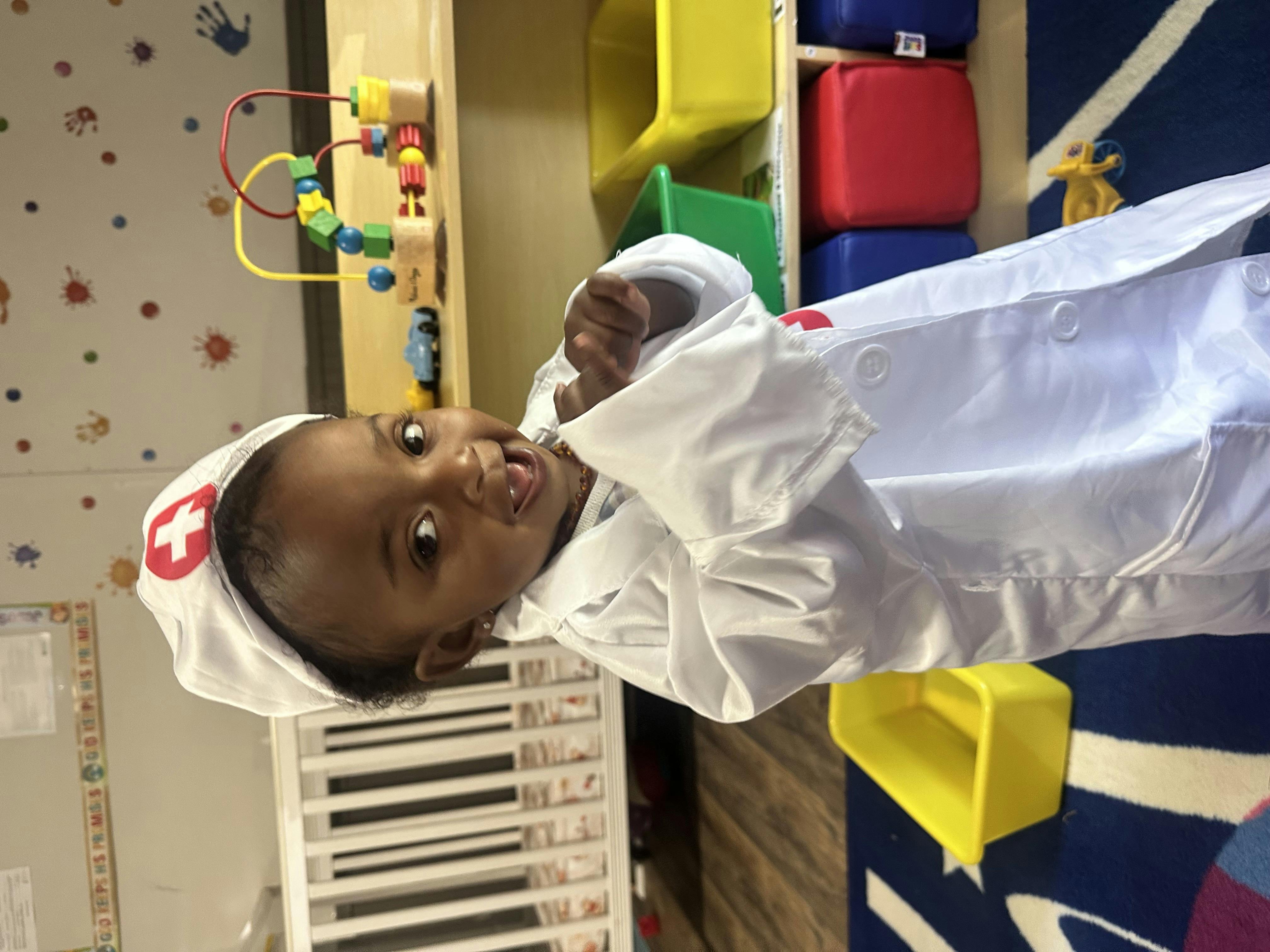 Child in a doctor's costume with a white coat and hat