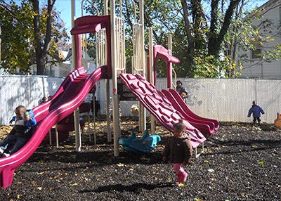 Children playing on a playground with slides
