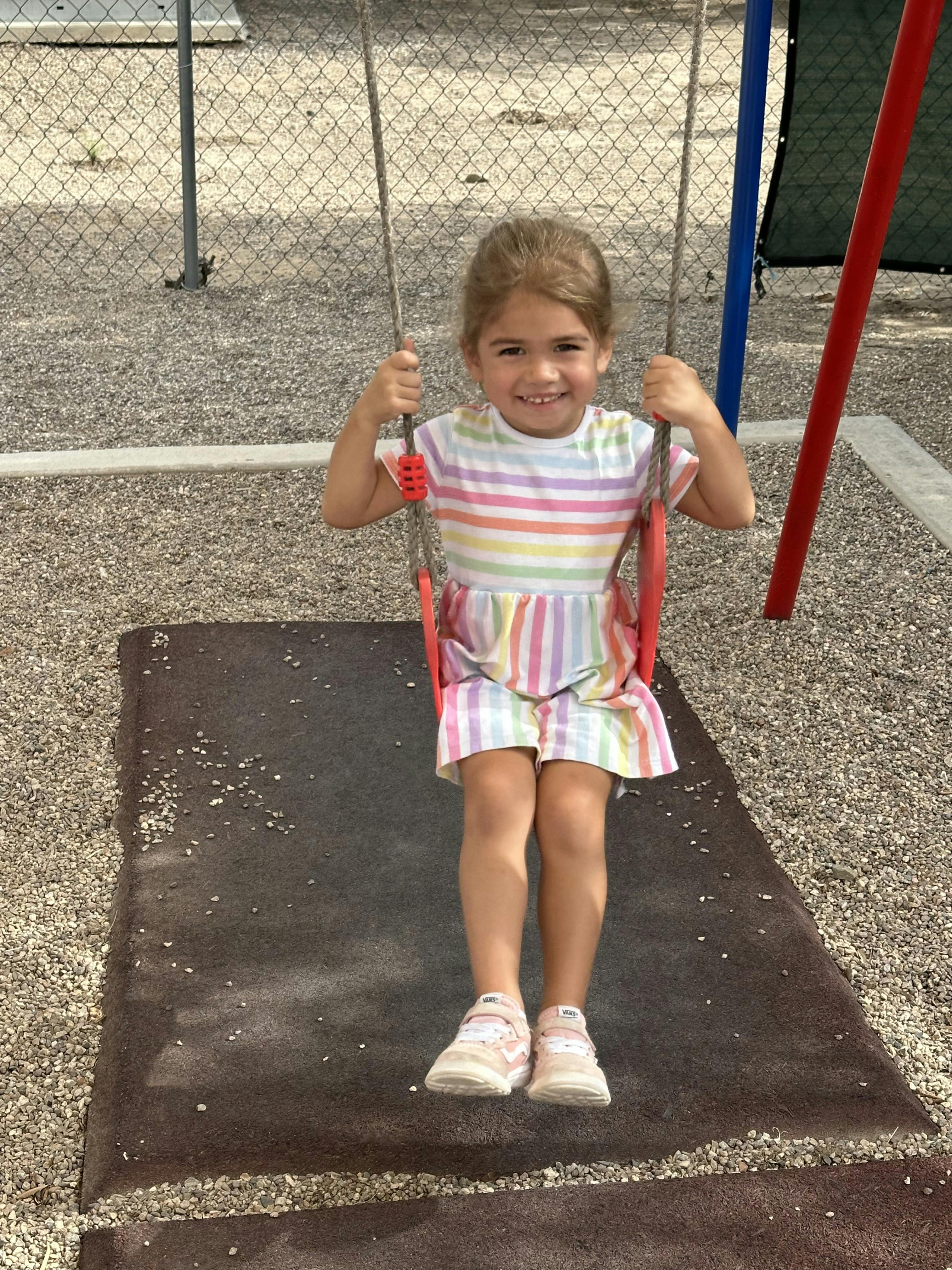 Child on a swing in a playground