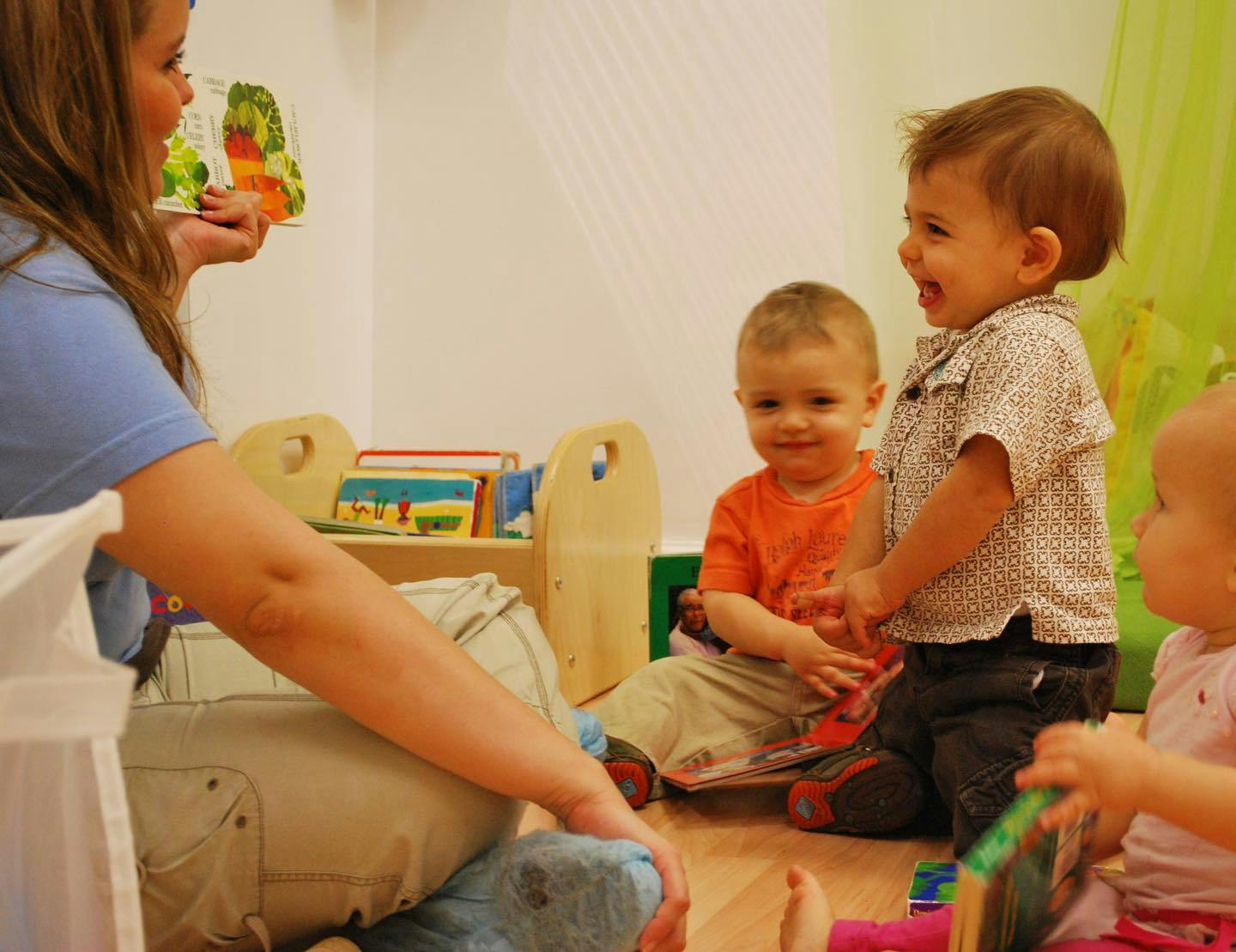 Person reading a book to children