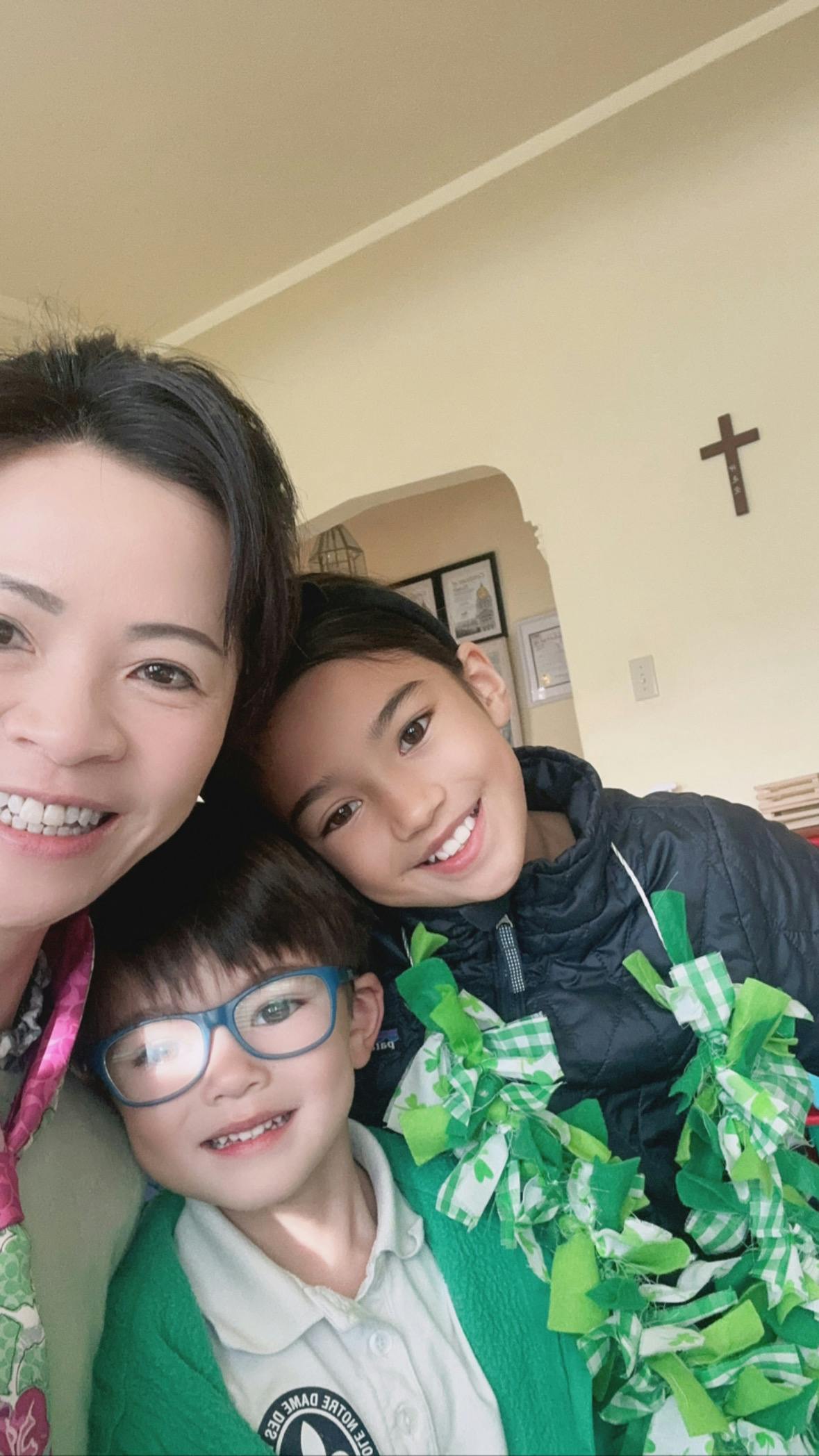 Person and two children smiling at the camera