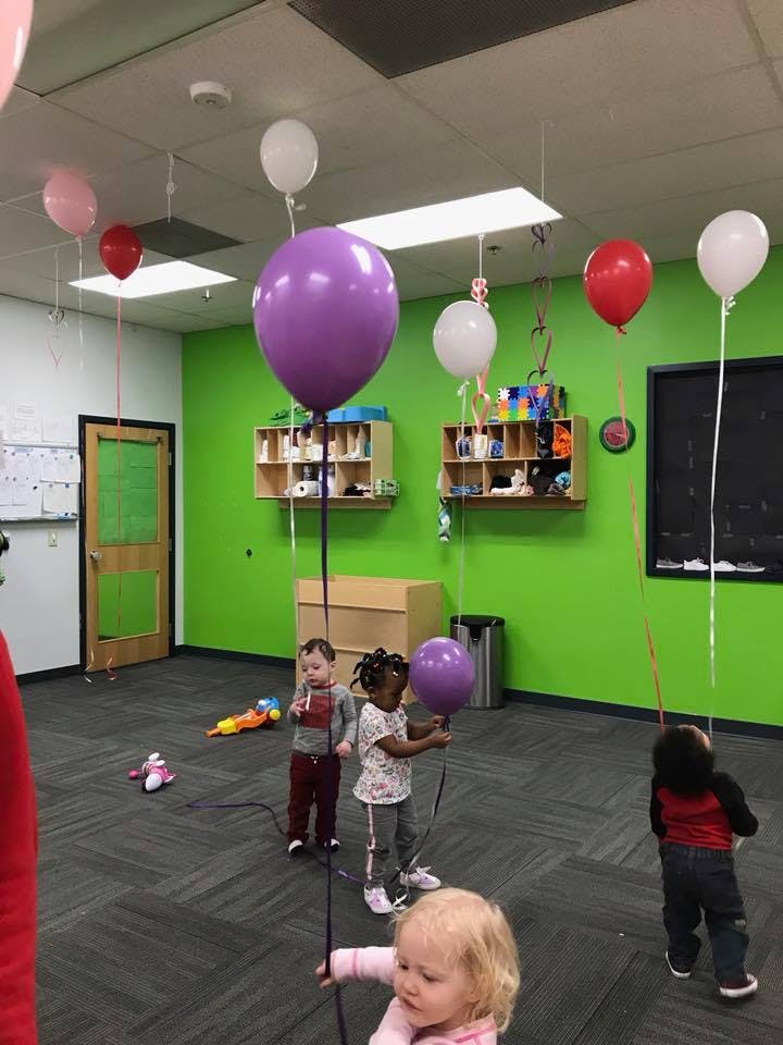 Children playing with balloons in a room