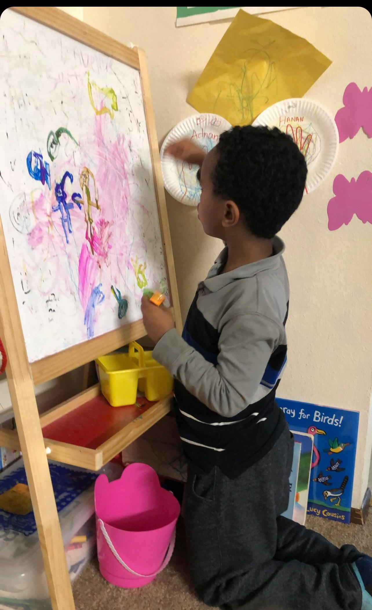 Child painting on an easel