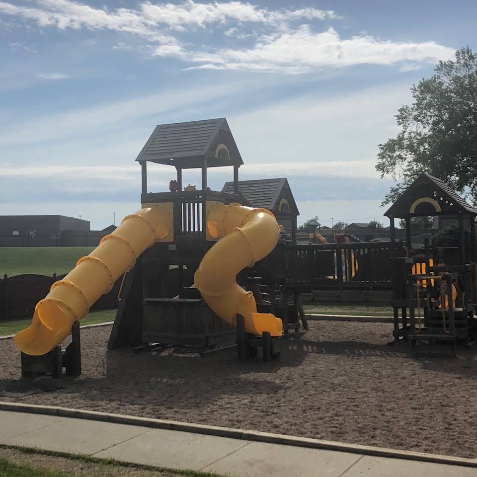 Playground with yellow slides and dark structures