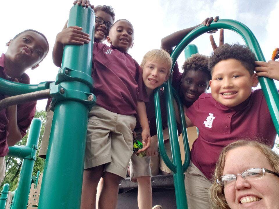 Children and an adult on playground equipment