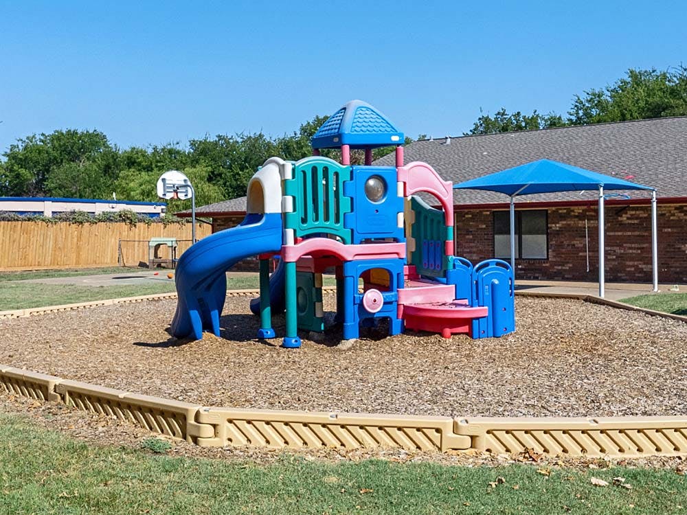 Colorful playground structure on wood chips