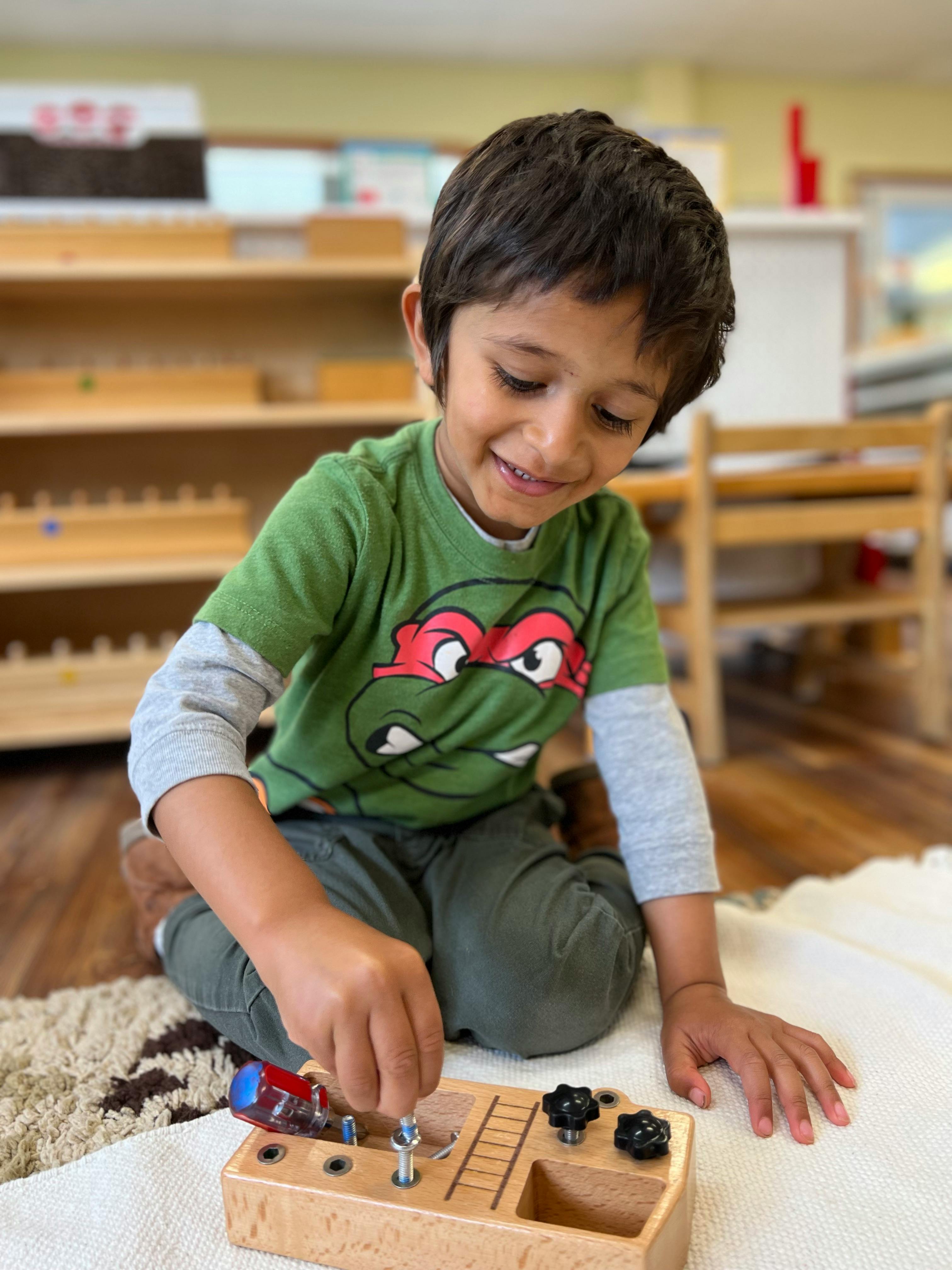 Child playing with a wooden toy on the floor
