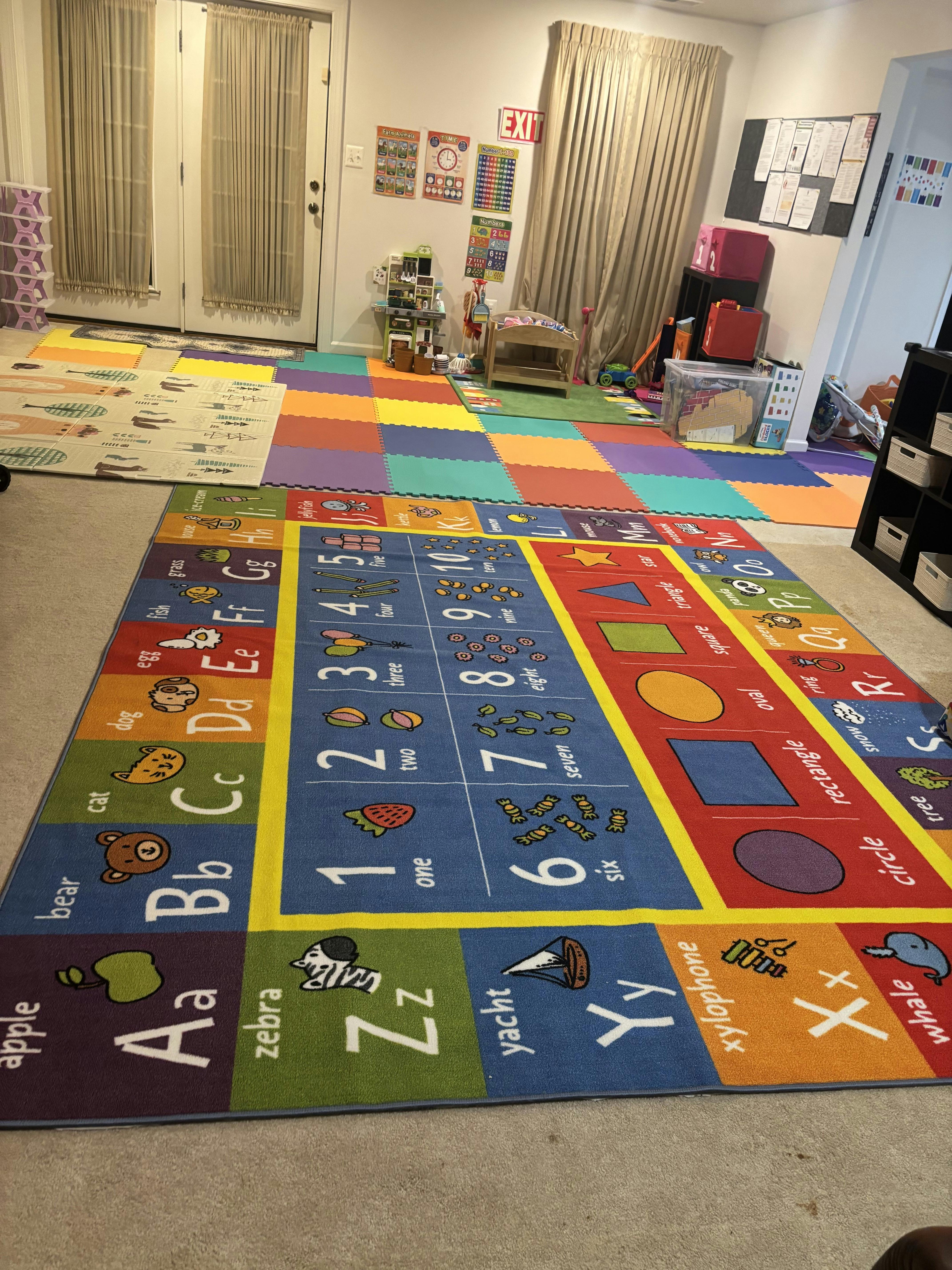 Colorful educational rug with letters and numbers in a playroom