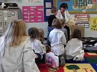 Adult reading to children in a classroom