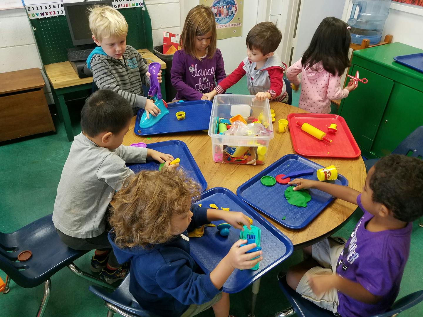Children playing with modeling clay at a table
