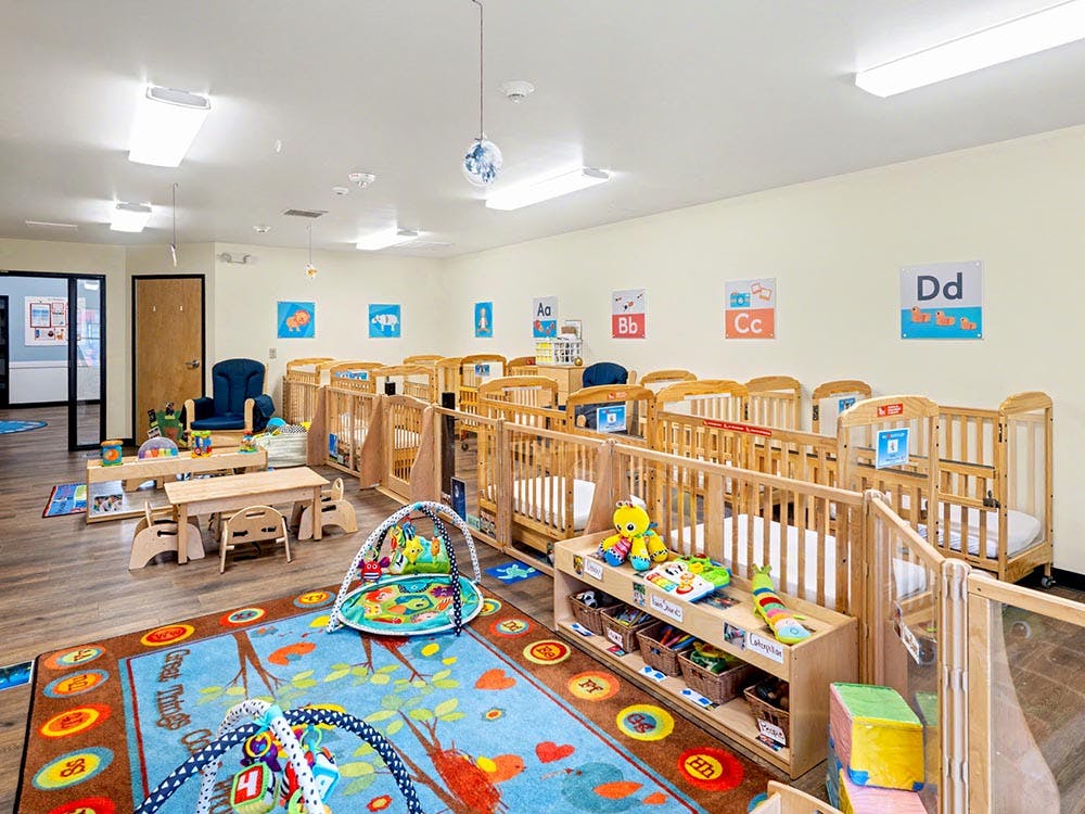 Cribs and play areas in an infant and toddler classroom