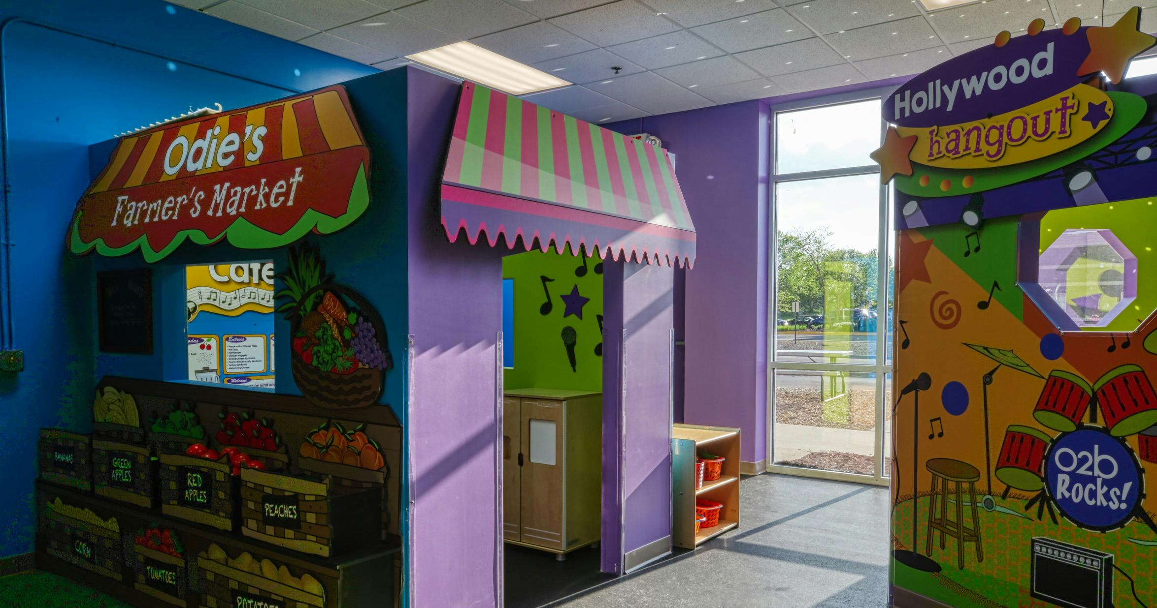 Colorful play areas for children, including a farmer's market and a Hollywood hangout