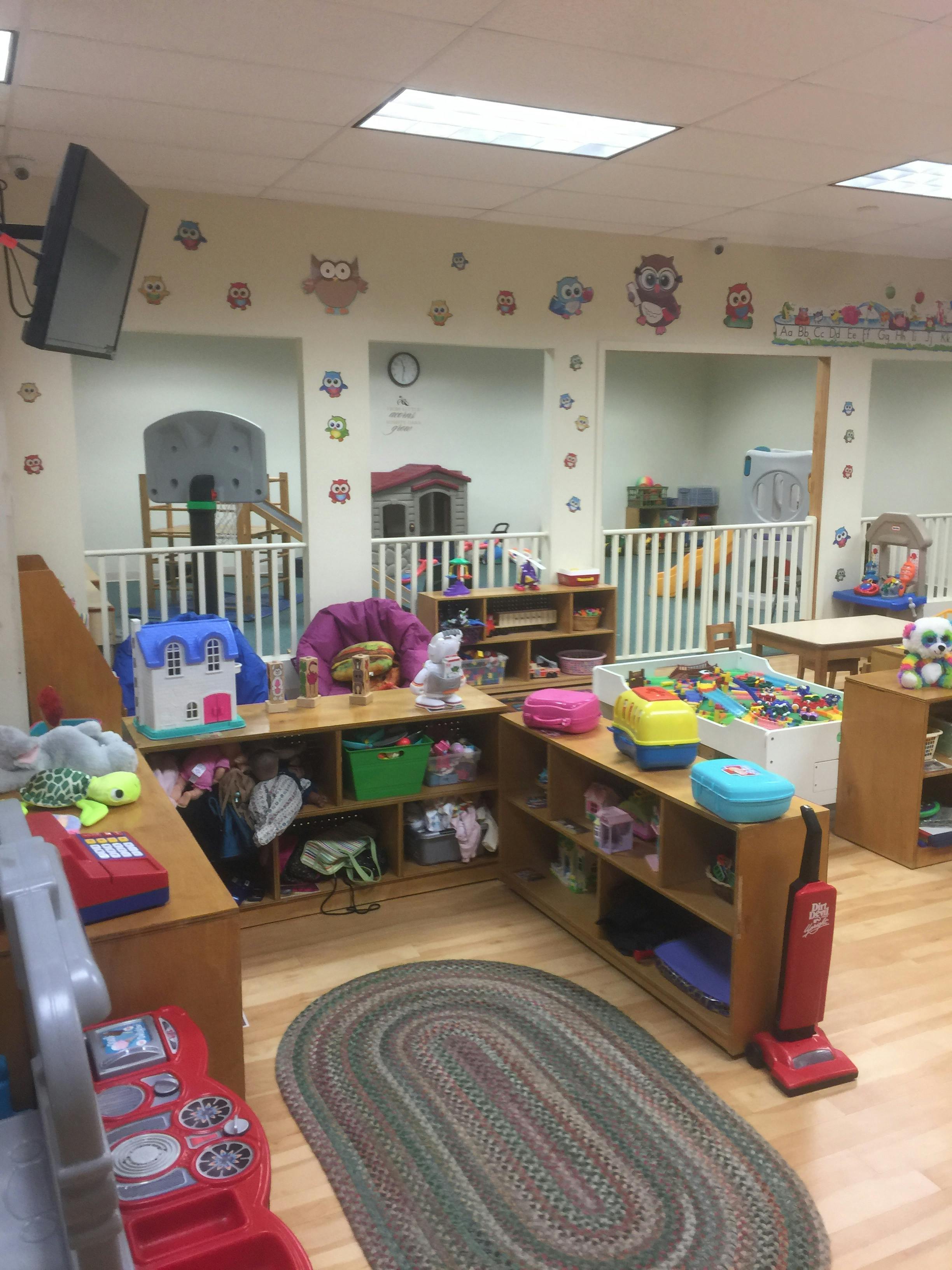 Playroom with toys, shelves, and a rug