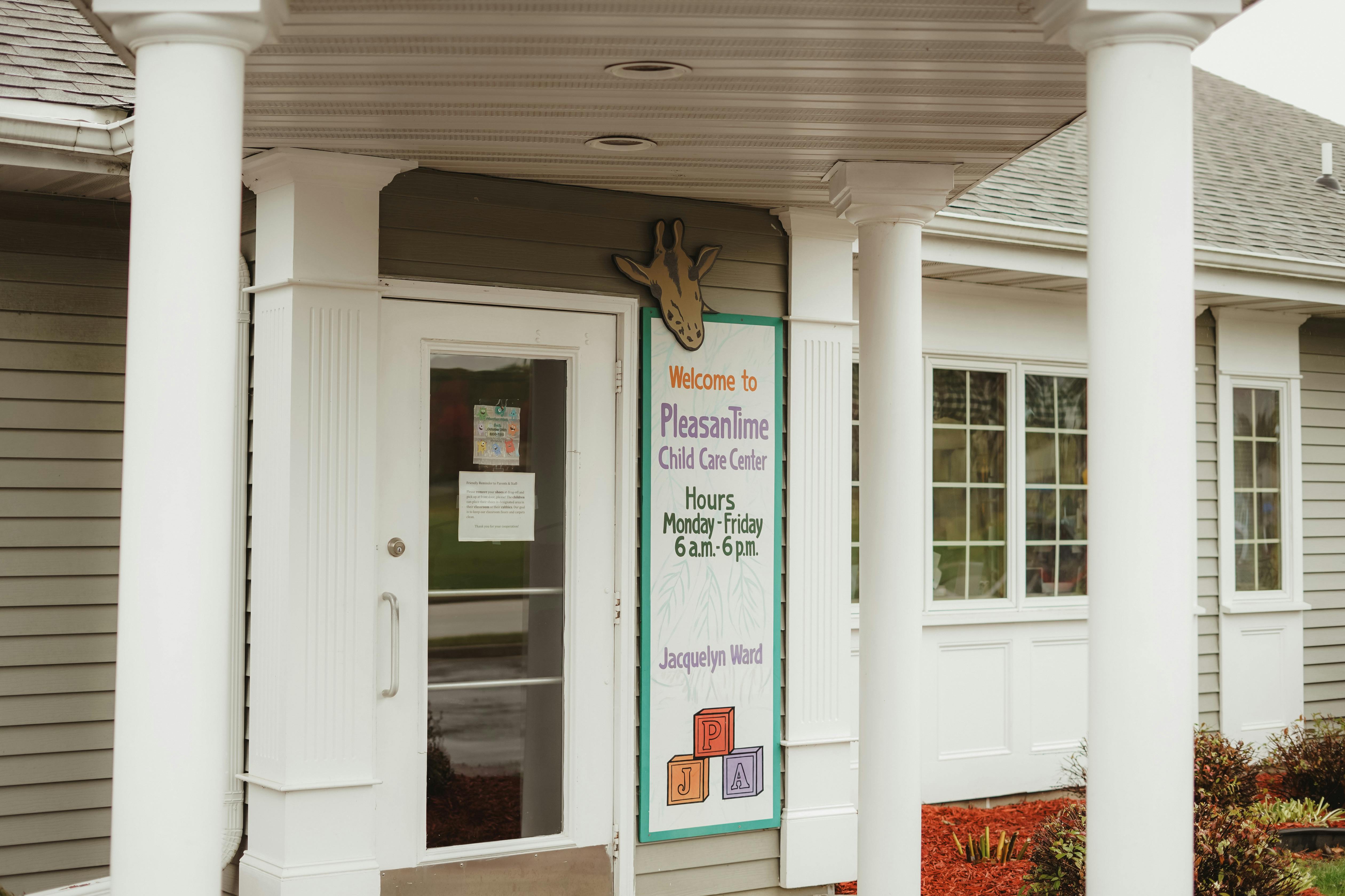 Sign for Pleasant Time Child Care Center with hours, Jacquelyn Ward, and J, P, A blocks