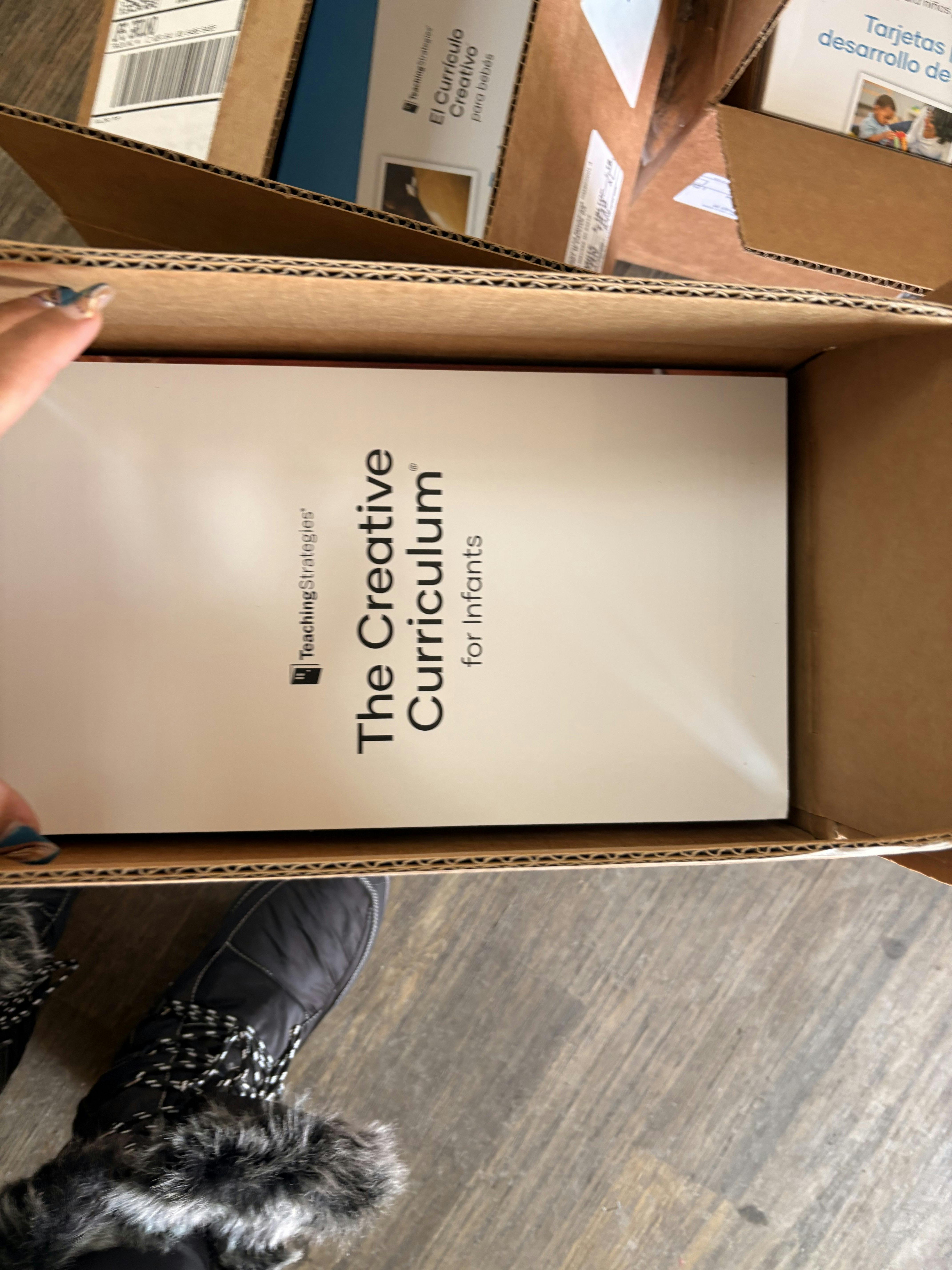 A box containing "The Creative Curriculum for Infants" text