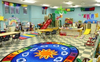 Playroom with tables, chairs, and play equipment