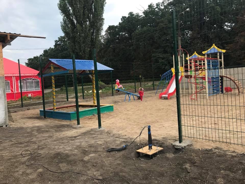 Playground with a sandbox, seesaw, and climbing structure