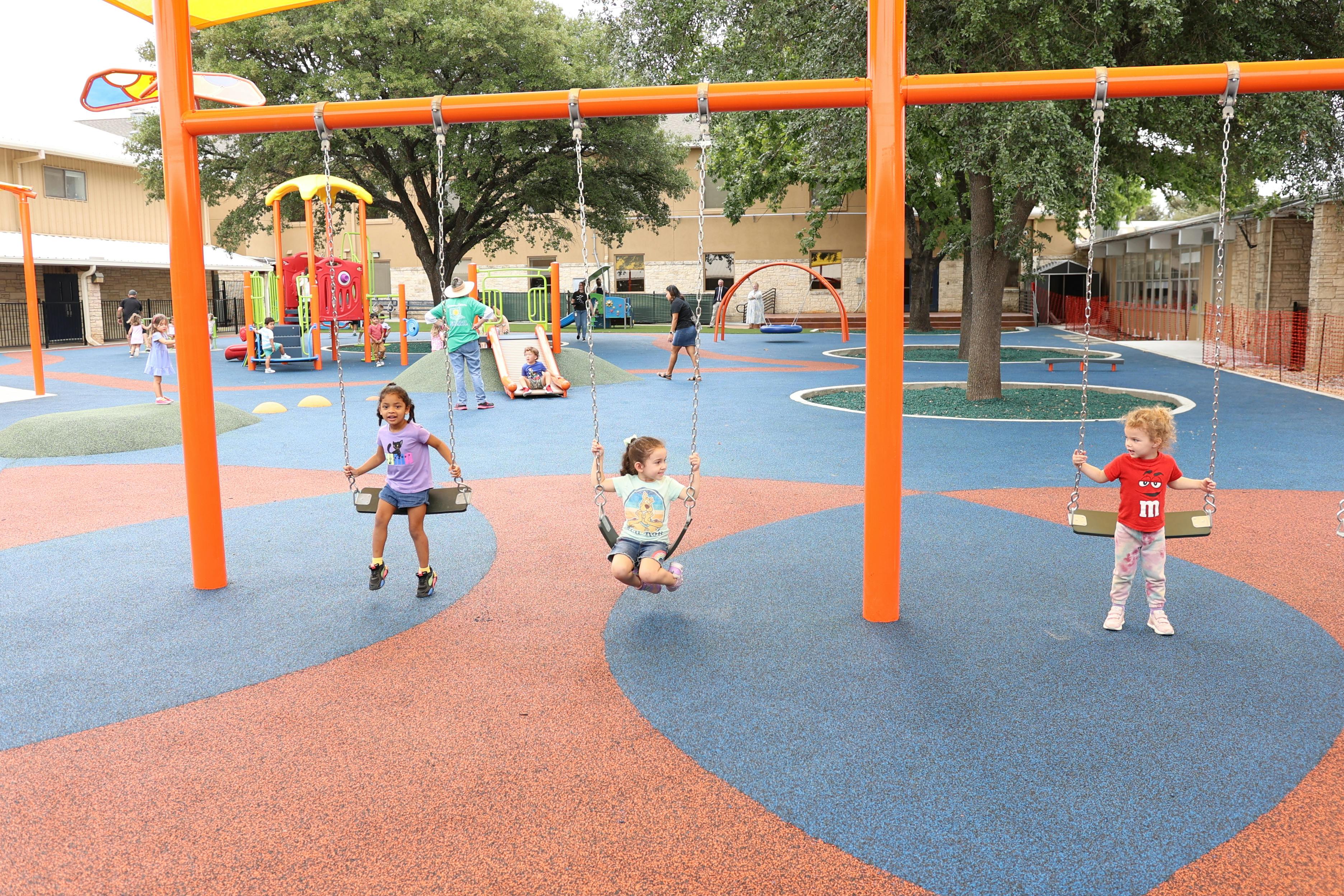Children playing on swings at a playground