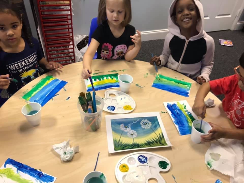 Children painting at a table